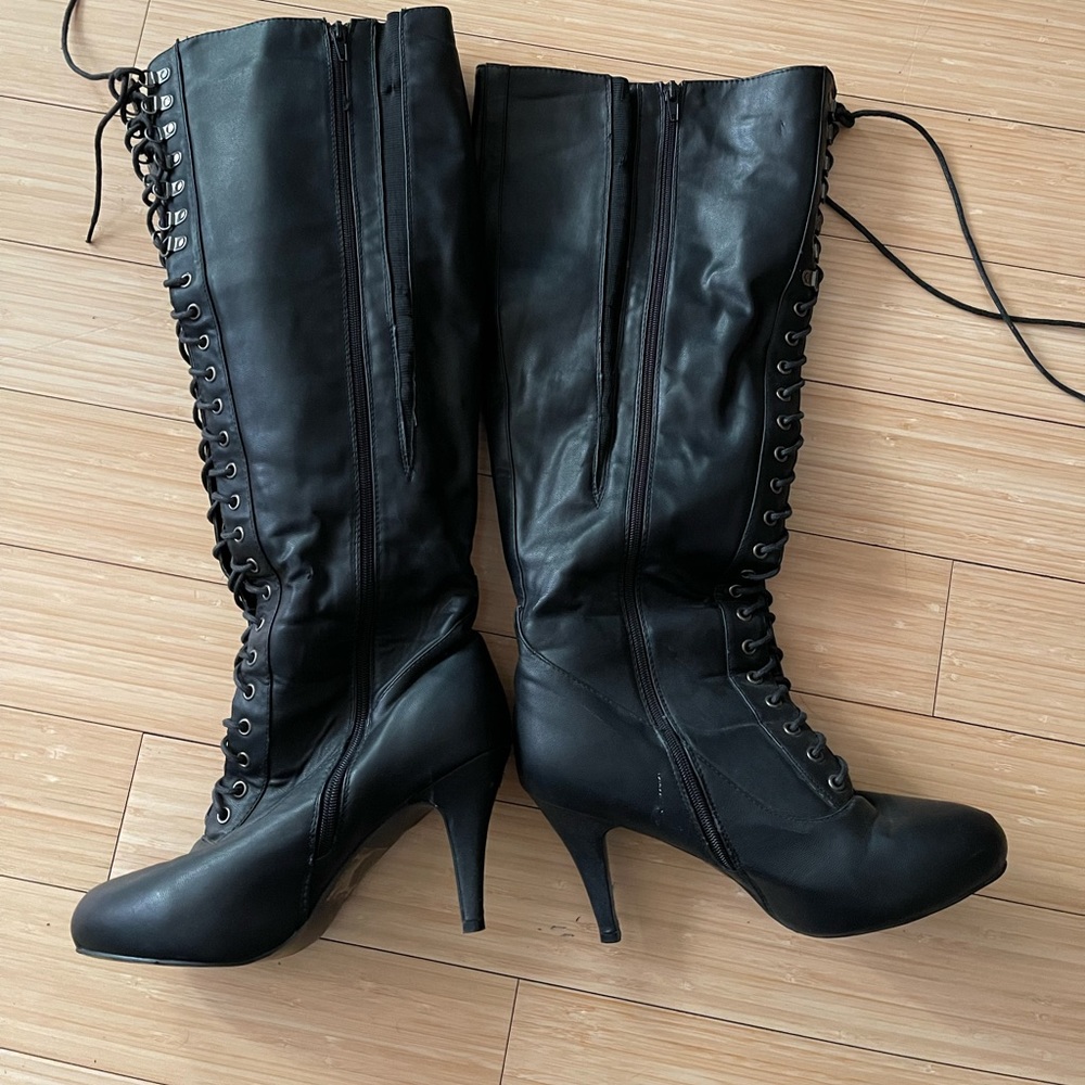 Torrid wide calf heel tie up boots.